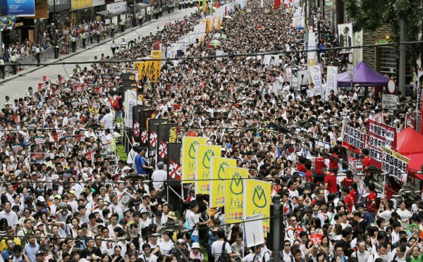 Over 500,000 marched against fake elections on July 1 – Socialist Action stall on right of picture.