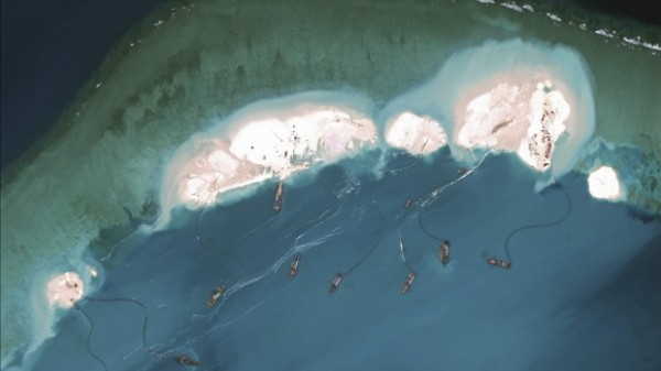 US spokesmen have protested over China's enlargement of islets and reefs in the South China Sea.